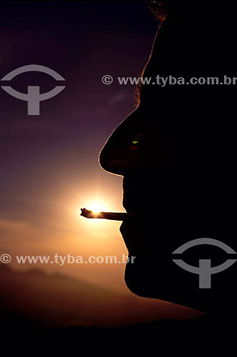  Silhouette of a man smoking marijuana - Brazil 