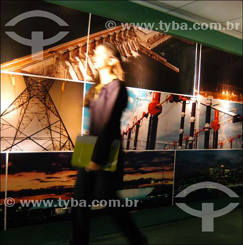  Woman walking in front of  a photo panel at Electric National System Operator (ONS) - Brasilia city - Federal District - Brazil 