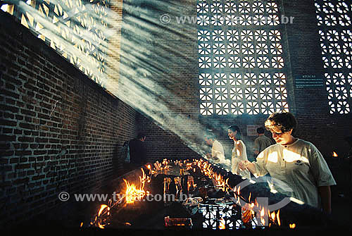  Religious people lighting candles for 