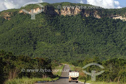  Truck on a  road in the foreground and mountain with 