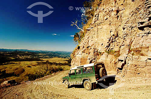  Car - Jeep at a dirt road with a landscape in the background 