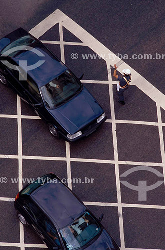  View from above of a traffic officer directing cars through an intersection 