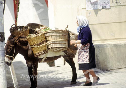  Subject: Woman next to cargo donkey Place: Mykonos - Greece  Date:  