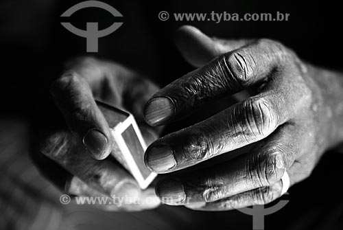  Subject: Detail of Mr. Pedro hands, an ancient dweller of the Alemao slum, playing samba in a matchbox  / Place:  Rio de Janeiro city - Rio de Janeiro state - Brazil  / Date: 11/2009 