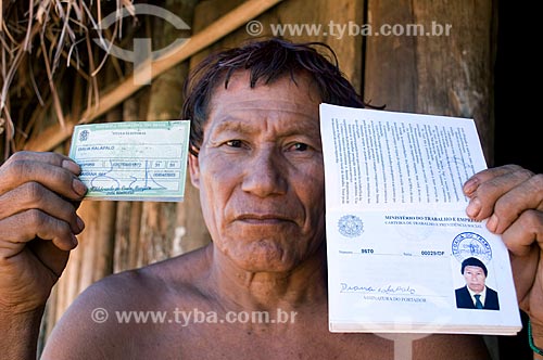  Dyaua Kalapalo indian holding his voter registration and worker papers - Awia Kalapalo village - Xingu Indian Park  - Querencia vity - Mato Grosso state (MT) - Brazil