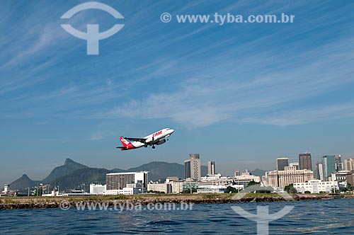  Subject: TAM Airlines plane taking off from Santos Dumont airport with buildings from downtown in the background / Place: Rio de Janeiro city  -  Rio de Janeiro state  -  Brazil / Date: 02/2011 