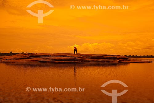  Subject: Man on top of rock in the Negro River / Place: Amazonas state (AM) - Brazil / Date: 10/2011 