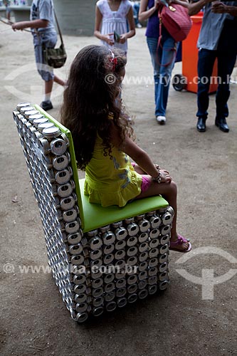  Girl sitting in a chair made from recycled aluminum cans exposed in the Peoples Summit at Rio+20 - Creator: Adriano Bezerra (Manufacturer of mobile home utilities cover tin) - Source: Caracaraí (RR)  - Rio de Janeiro city - Rio de Janeiro state (RJ) - Brazil