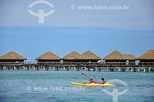  Subject: Couple in a kayak with the bungalows of a resort in the background / Place: Huahine Island - French Polynesia - Oceania / Date: 10/2012 