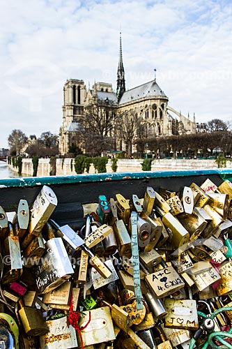  Subject: Padlocks trapped in grids of the Pont de lArchevêché (Archbishop Bridge) - 1828 - with the Notre-Dame of Paris Cathedral (1163) in the background / Place: Paris - France - Europe / Date: 01/2013 