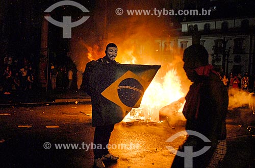  Protester with barricade with garbage burned in the background during the manifestation known as Free Pass Movement  - Rio de Janeiro city - Rio de Janeiro state (RJ) - Brazil