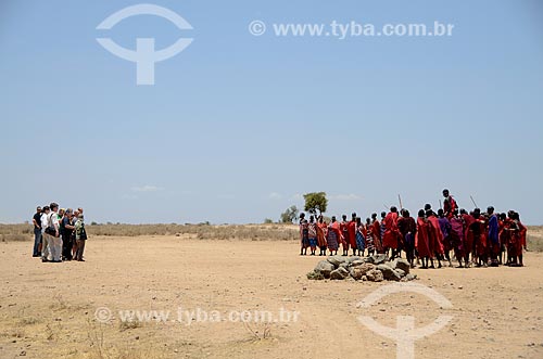  Tourists watching the Masai tribe dancing the Adumu - also know as the jumping dance - a competition between them and also a dance of welcome - Amboseli National Park  - Kajiado city - Rift Valley province - Kenya