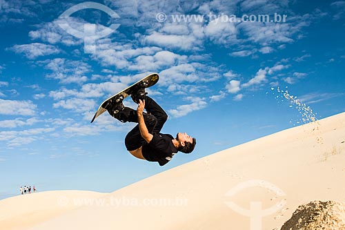  Man practicing sandboarding in the dunes of Rio Vermelho State Park  - Florianopolis city - Brazil