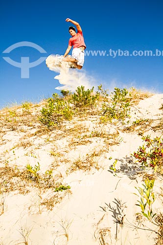  Man practicing sandboarding in the dunes of Joaquina Beach  - Florianopolis city - Brazil