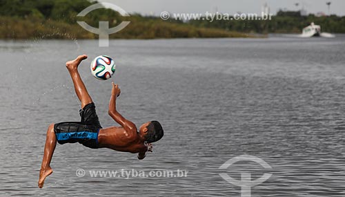  Subject: Boy playing with Adidas Brazuca - official soccer ball of the FIFA World Cup 2014 / Place: Manaus city - Amazonas state (AM) - Brazil / Date: 01/2014 