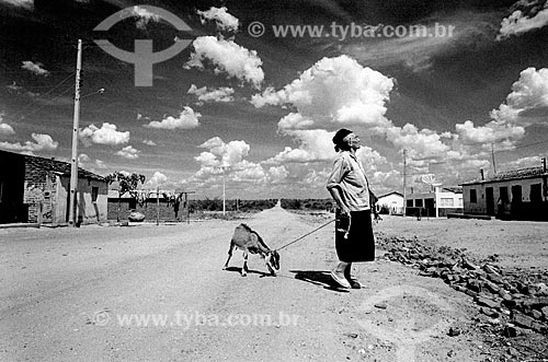  Woman carrying goat in the backwoods  - Canudos city - Bahia state (BA) - Brazil