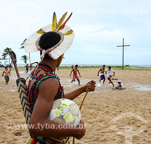  Indian of Pataxo tribe playing soccer with the Cross in Coroa Vermelha - region where disembarked Pedro Alvares Cabral and where the first Mass was held in Brazil - in the background  - Santa Cruz Cabralia city - Bahia state (BA) - Brazil