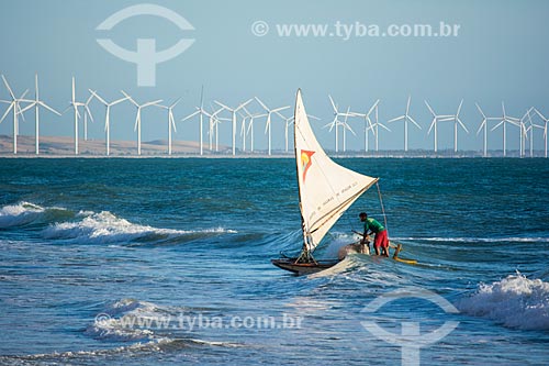  fisherman in raft - Canoa Quebrada Beach with the Canoa Quebrada Wind Farm in the background  - Aracati city - Ceara state (CE) - Brazil