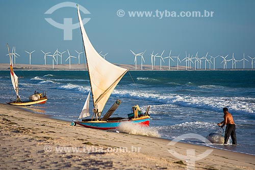  fisherman in raft - Canoa Quebrada Beach with the Canoa Quebrada Wind Farm in the background  - Aracati city - Ceara state (CE) - Brazil