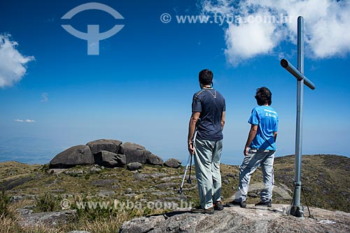  Men and cross in Acu Mountain summit with the rock formations known as Acu Castles in the background  - Petropolis city - Rio de Janeiro state (RJ) - Brazil