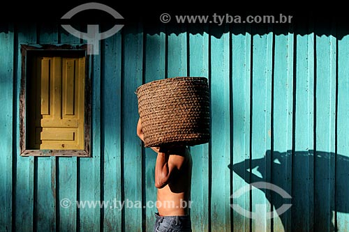  Riverine man holding straw basket with Guarana fruits (Paullinia cupana)  - Maues city - Amazonas state (AM) - Brazil