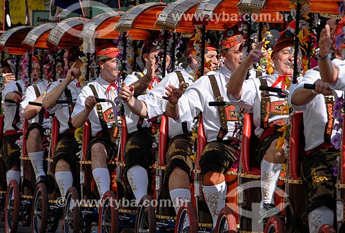  People with German costumes - bicycle with several places known as Centopeia or Centipede - during parade of Oktoberfest  - Blumenau city - Santa Catarina state (SC) - Brazil