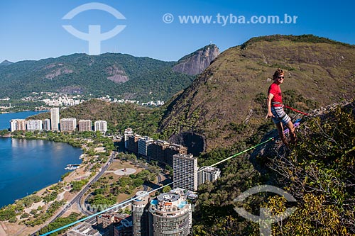  Man preparing strip to slackline - Cantagalo Hill with Christ the Redeemer in the background  - Rio de Janeiro city - Rio de Janeiro state (RJ) - Brazil