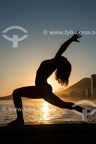  Woman practicing Yoga - Mirante do Leme - also known as Caminho dos Pescadores (Fisherman Path) - virabhadrasana movement (warrior)  - Rio de Janeiro city - Rio de Janeiro state (RJ) - Brazil