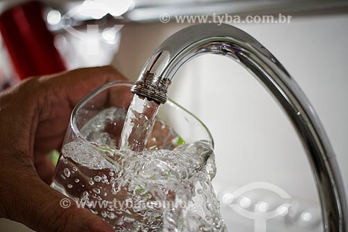  Open faucet filling glass of water  - Brazil