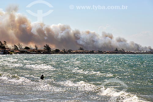  View of Manguinhos Beach with smoke in the background caused by fired in the Rasa Beach area  - Armacao dos Buzios city - Rio de Janeiro state (RJ) - Brazil