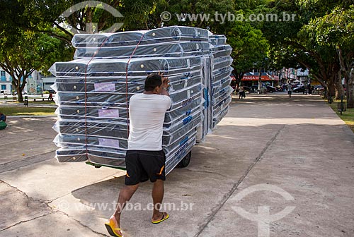  Worker carrying mattresses in wheelbarrow  - Belem city - Para state (PA) - Brazil