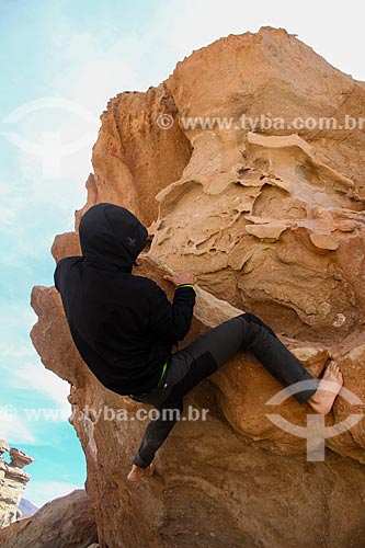  Man climbing rock near to Uyuni Salt Flat  - Uyuni city - Potosi department - Bolivia