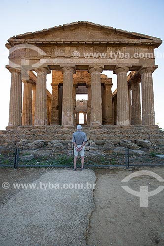  Tourist observing - Temple of Concordia - Valle dei Templi (Valley of the Temples) - ancient greek city Akragas  - Agrigento city - Agrigento province - Italy