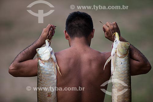  Riverine man carrying aruana fish  - Manaus city - Amazonas state (AM) - Brazil