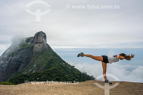  Woman practicing Yoga - virabhadrasana C movement (warrior III) - Pedra Bonita (Bonita Stone) - with the Rock of Gavea in the background  - Rio de Janeiro city - Rio de Janeiro state (RJ) - Brazil