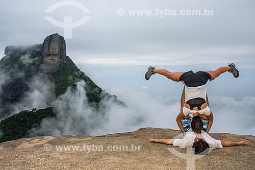  Couple executing the acroyoga movement - Pedra Bonita (Bonita Stone) - with the Rock of Gavea in the background  - Rio de Janeiro city - Rio de Janeiro state (RJ) - Brazil