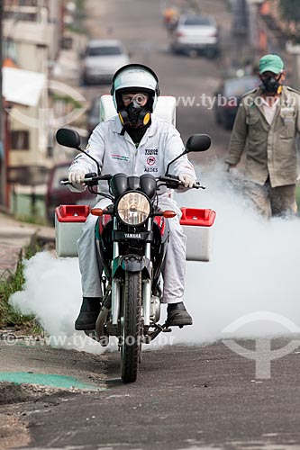  Motorcycle with Ultra-Low Volume (ULV) equipment - also known as cold fogging machine - combat to yellow fever mosquito (Aedes aegypti)  - Manaus city - Amazonas state (AM) - Brazil