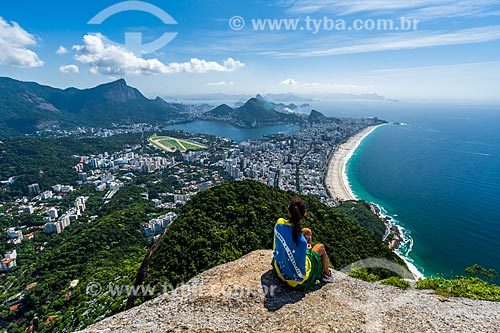  Woman in summit of the Morro Dois Irmaos (Two Brothers Mountain) with the Christ the Redeemer in the background  - Rio de Janeiro city - Rio de Janeiro state (RJ) - Brazil