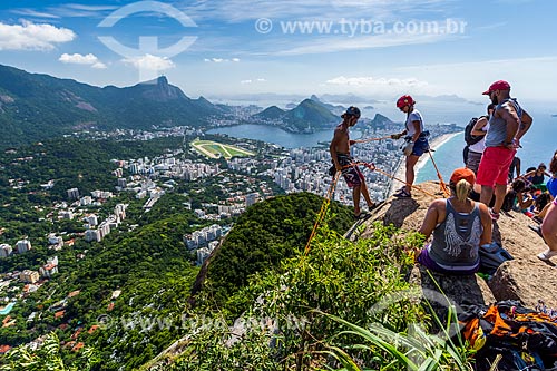  Persons practicing rappelling in summit of the Morro Dois Irmaos (Two Brothers Mountain) with the Christ the Redeemer in the background  - Rio de Janeiro city - Rio de Janeiro state (RJ) - Brazil