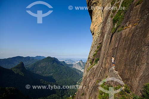  Man on the hillside of Rock of Gavea with the Tijuca Massif in the background  - Rio de Janeiro city - Rio de Janeiro state (RJ) - Brazil