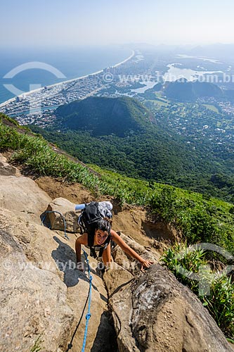 Woman climbing the Rock of Gavea with Barra da Tijuca in the background  - Rio de Janeiro city - Rio de Janeiro state (RJ) - Brazil