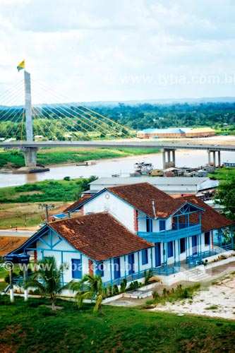  Historic house on the banks of the Jurua River with the cable-stayed bridge in the background  - Cruzeiro do Sul city - Acre state (AC) - Brazil