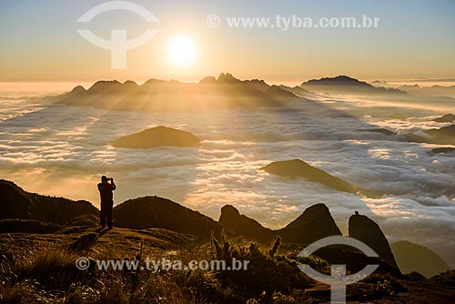  Tourist photographing dawn from trail to Pedra do Sino (Bell Stone) - Serra dos Orgaos National Park  - Teresopolis city - Rio de Janeiro state (RJ) - Brazil