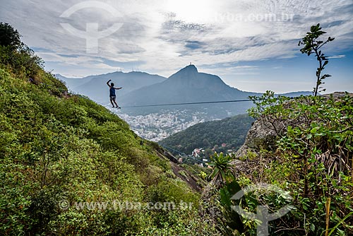  Practitioner of slackline - Cabritos Mountain (Kid Goat Mountain) - with the Christ the Redeemer in the background  - Rio de Janeiro city - Rio de Janeiro state (RJ) - Brazil