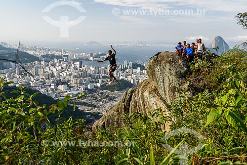  Practitioner of slackline - Cabritos Mountain (Kid Goat Mountain) - with the Botafogo neighborhood in the background  - Rio de Janeiro city - Rio de Janeiro state (RJ) - Brazil