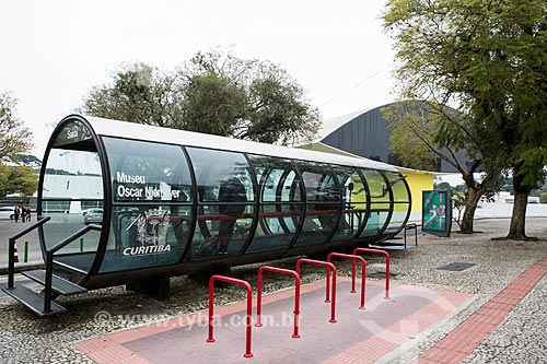  Tubular station of articulated buses - also known as the Tube Station - with the Oscar Niemeyer Museum in the background  - Curitiba city - Parana state (PR) - Brazil