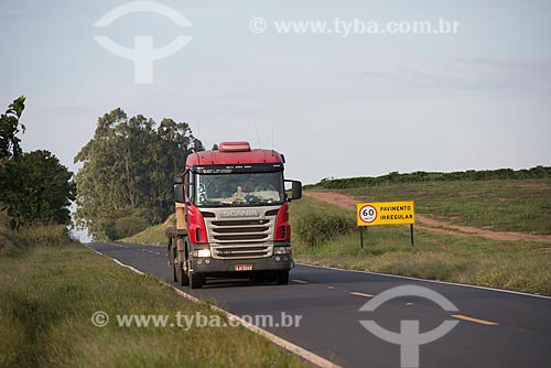 Truck traveling in the SP-331 highway and plate with warning irregularities in the background  - Alvinlandia city - Sao Paulo state (SP) - Brazil