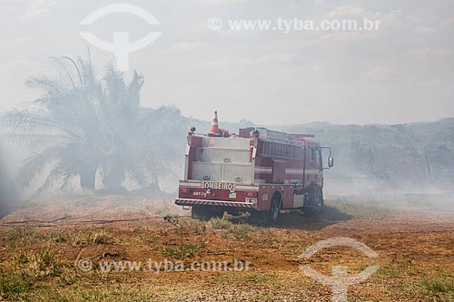  Fire truck fighting fire on the banks of the North Perimetral Avenue (GO-070) during dry season  - Goiania city - Goias state (GO) - Brazil