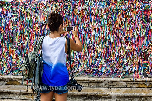  Woman photographing the colorful ribbons - grids of the Nosso Senhor do Bonfim Church (1754)  - Salvador city - Bahia state (BA) - Brazil