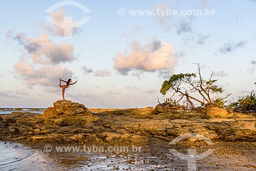  Woman practicing Yoga - 3nd Beach and 4nd Beach waterfront - Dandayamana-dhanurasana movement  - Cairu city - Bahia state (BA) - Brazil